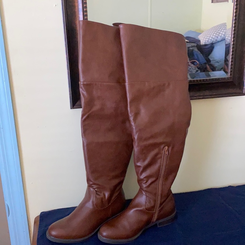 Over the knee brown leather boots.